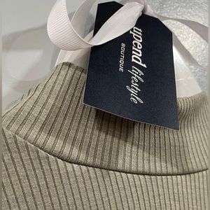 Chic layering. Sage green mock neck bodysuit. Thong back snap closure.